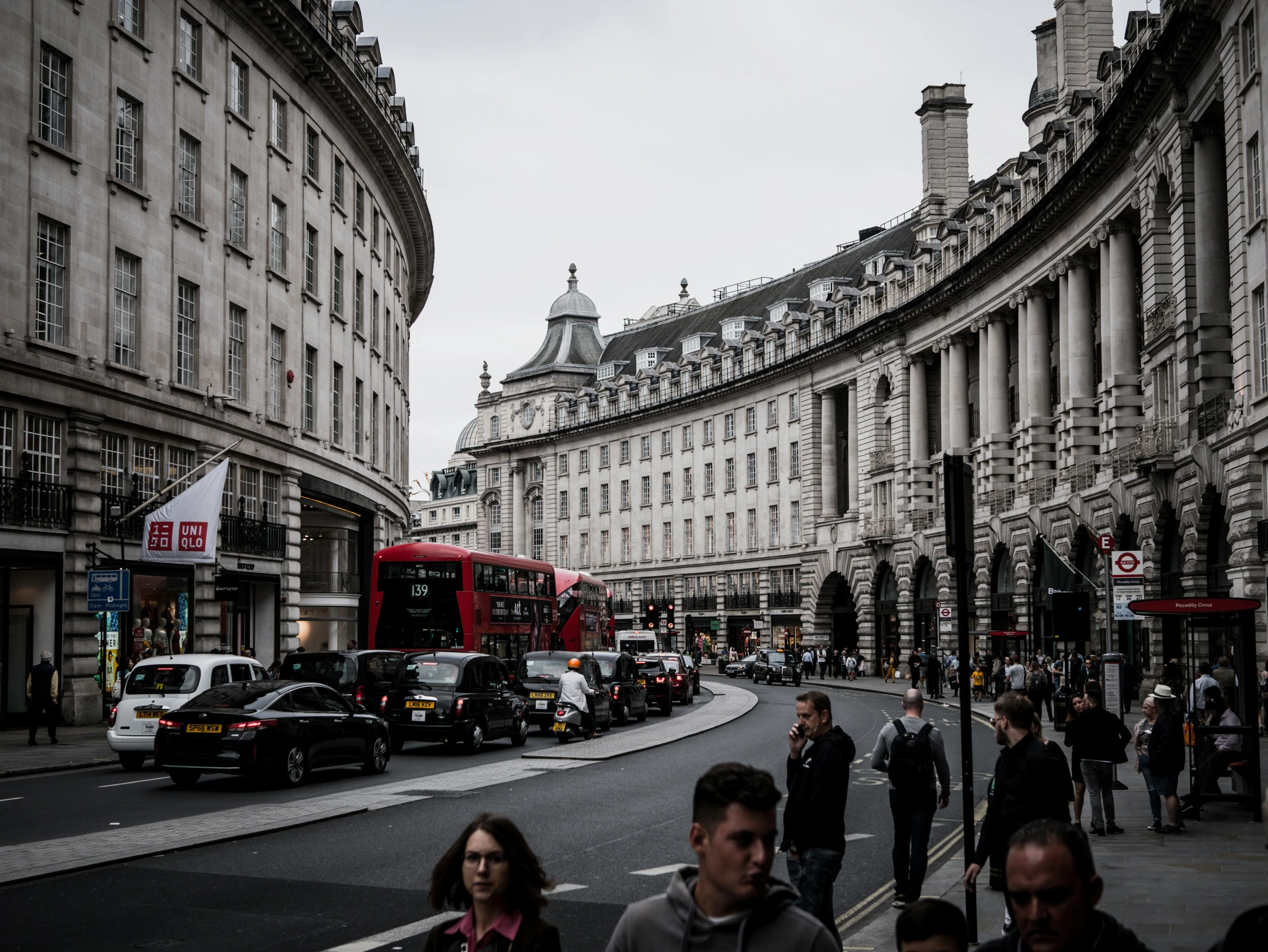 a view of an urban city street with cars on the road