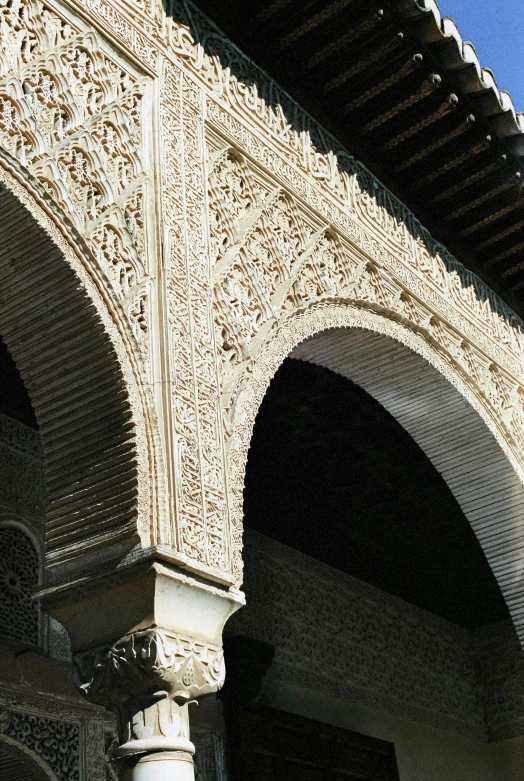 arched stone building with columns on top of it