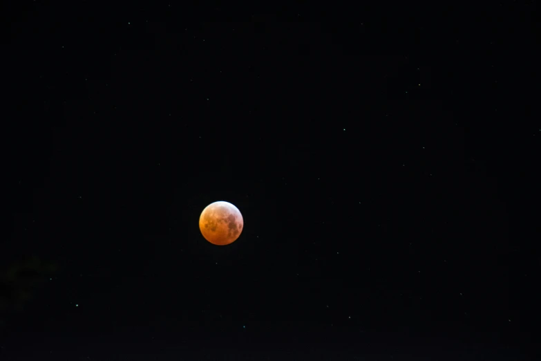 the supermoon that is seen over a house