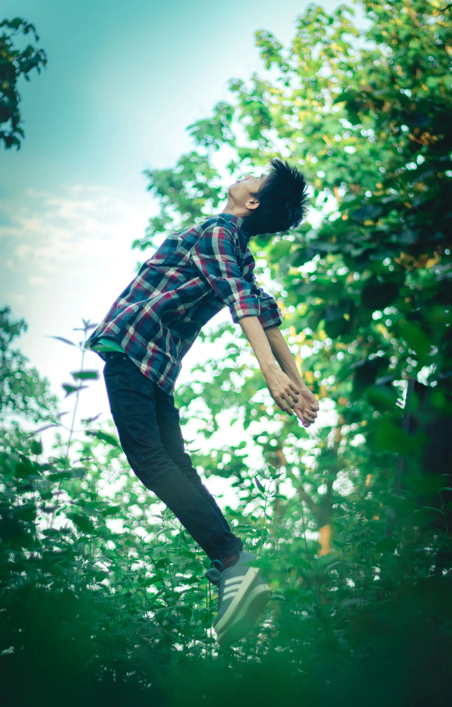 a man doing skateboard tricks in a park