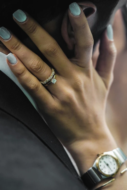 a person holding a watch and talking on a cell phone