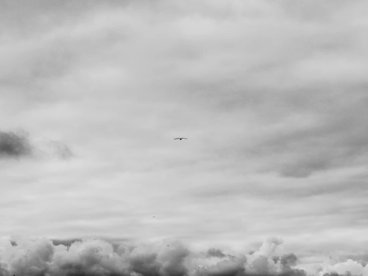 an airplane that is flying through the cloudy sky