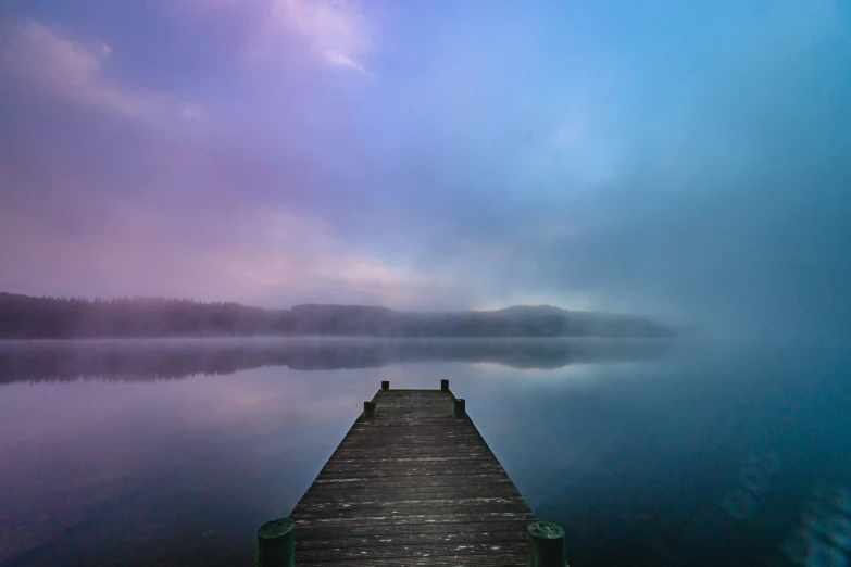 this is a pograph of an old dock with a man walking alone