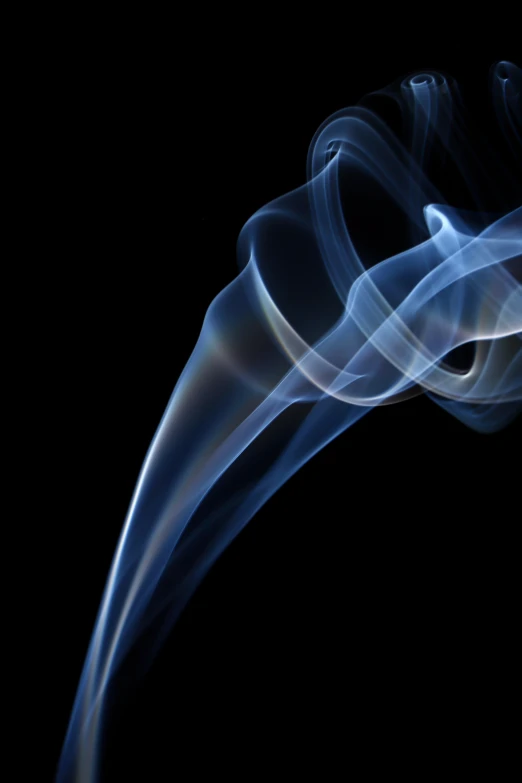 a dark blue smoke swirls against a black background