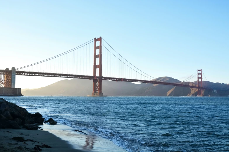 a body of water near the beach and a large bridge