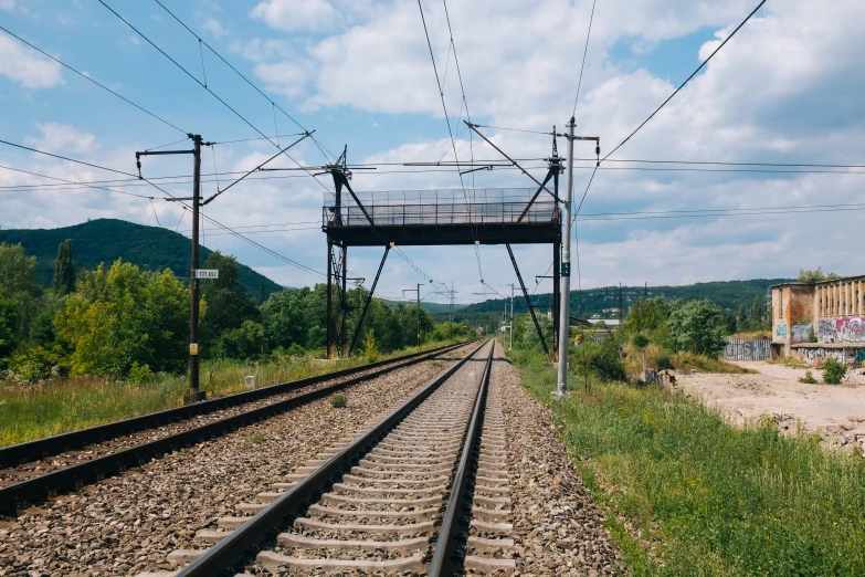 an old railroad track with some wooden things on it