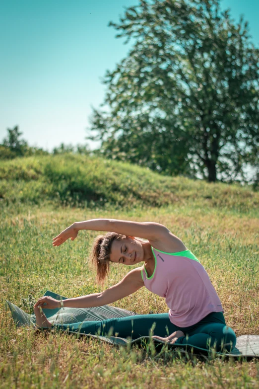 a woman doing an yoga pose on a mat