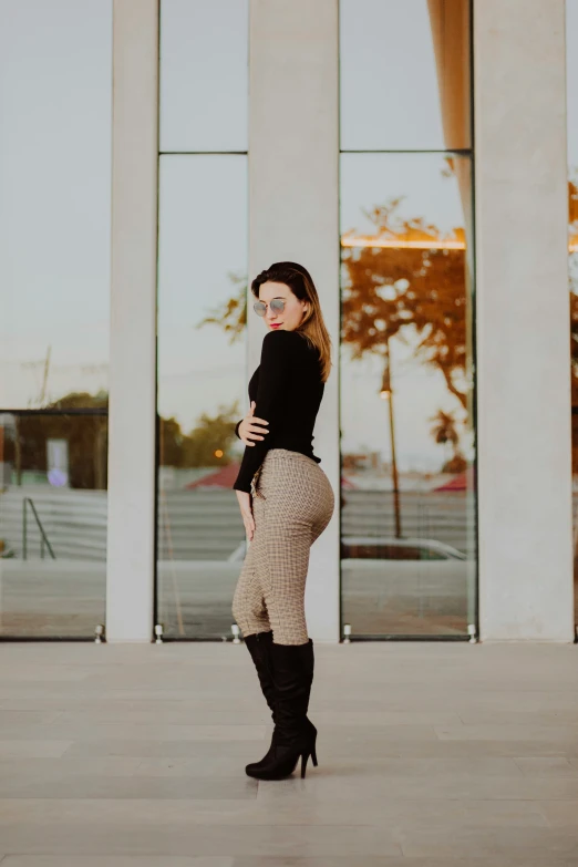 a woman is standing outside of a building