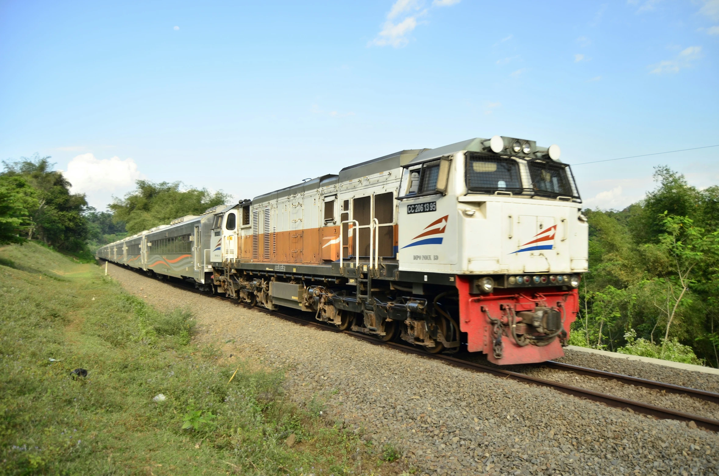 the train is moving along the tracks in the country