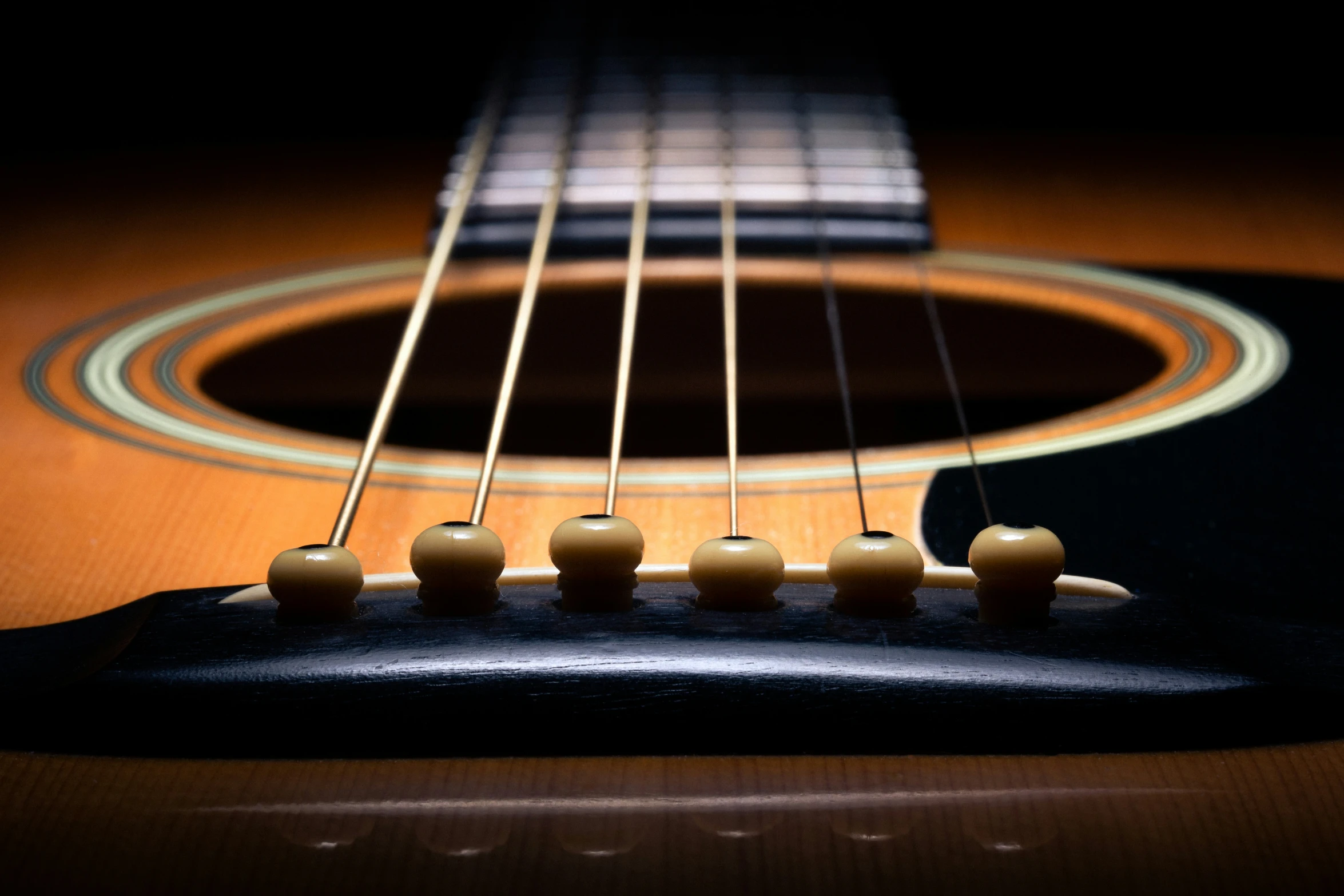 guitar strings with three small white balls on them