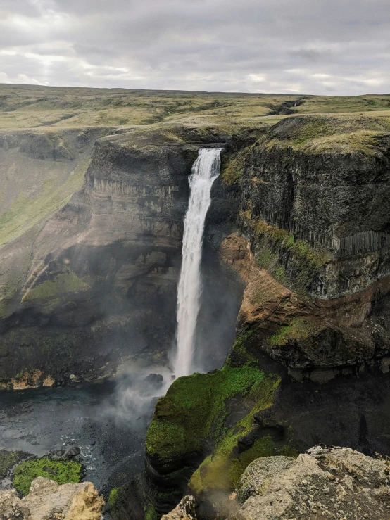 an aerial s of a waterfall that appears to have water pouring from the side