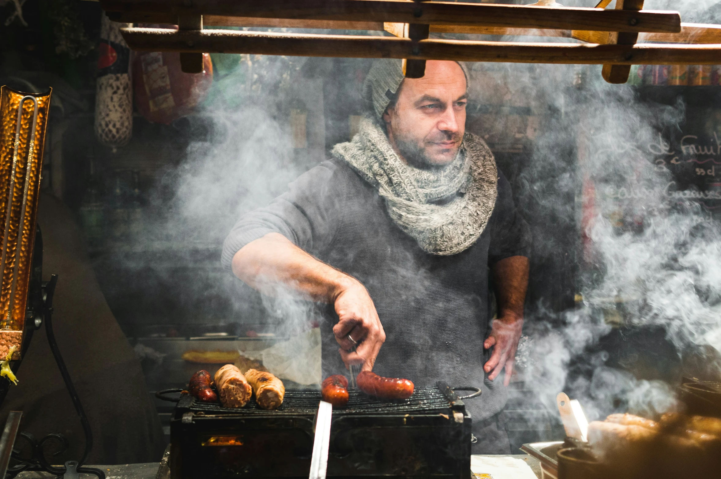 a man in a kitchen preparing  dogs