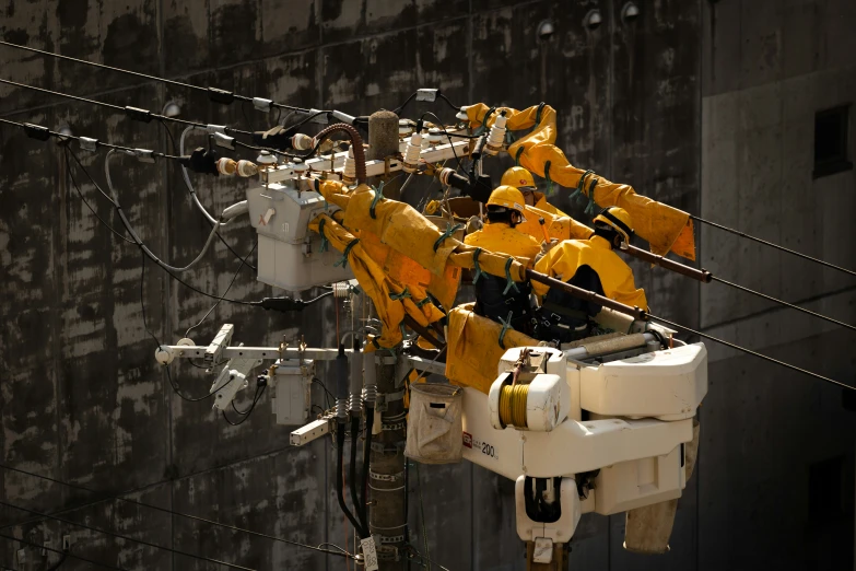 a large power line with multiple yellow electrical equipment hanging on it