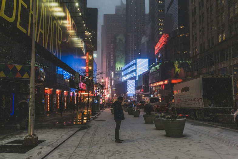 a person is standing on the street in the rain