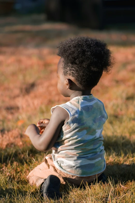 a  sitting in the grass looking away