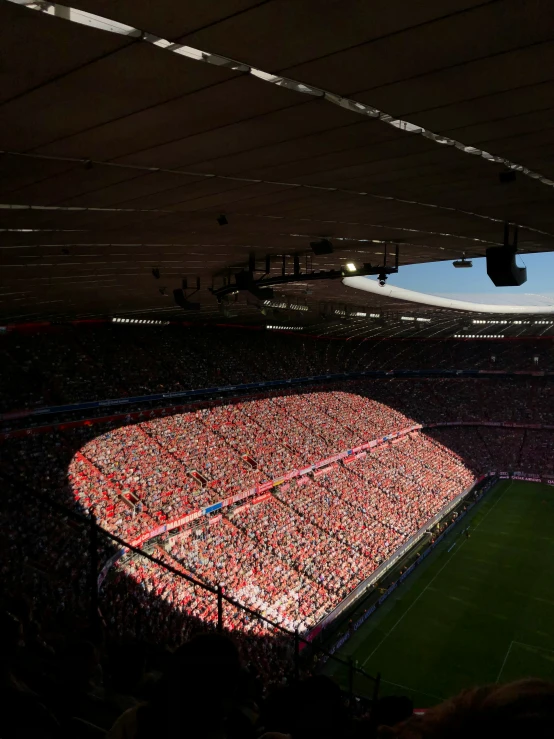 a crowded stadium with lights all around it