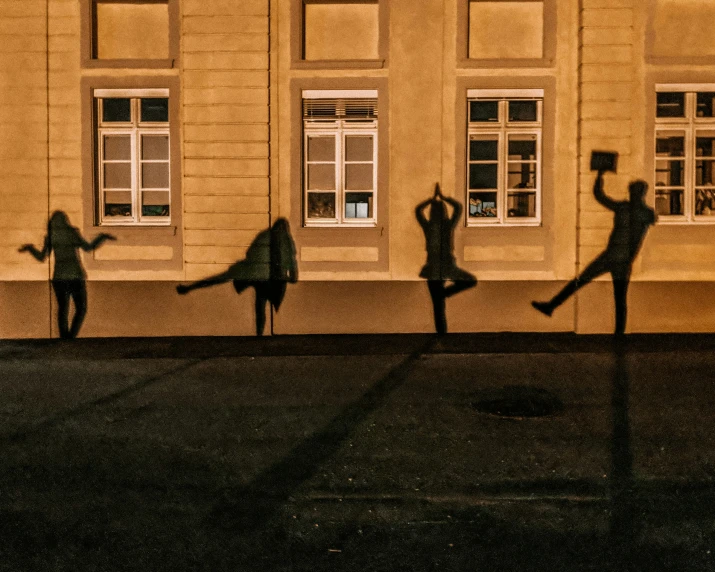 shadow of dancers outside of a building