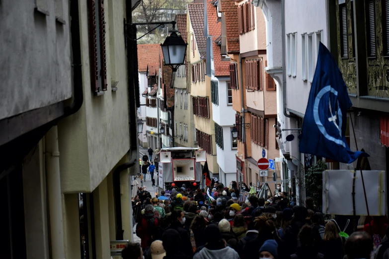 many people are walking down the street while carrying flags