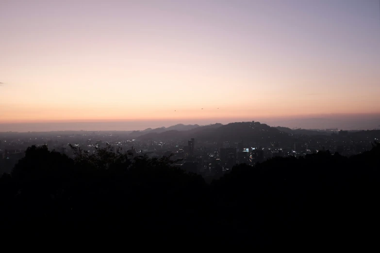 a view of mountains at sunset and the sky in the foreground