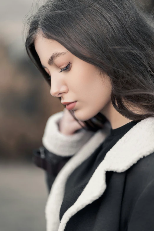 a beautiful woman holding onto her phone