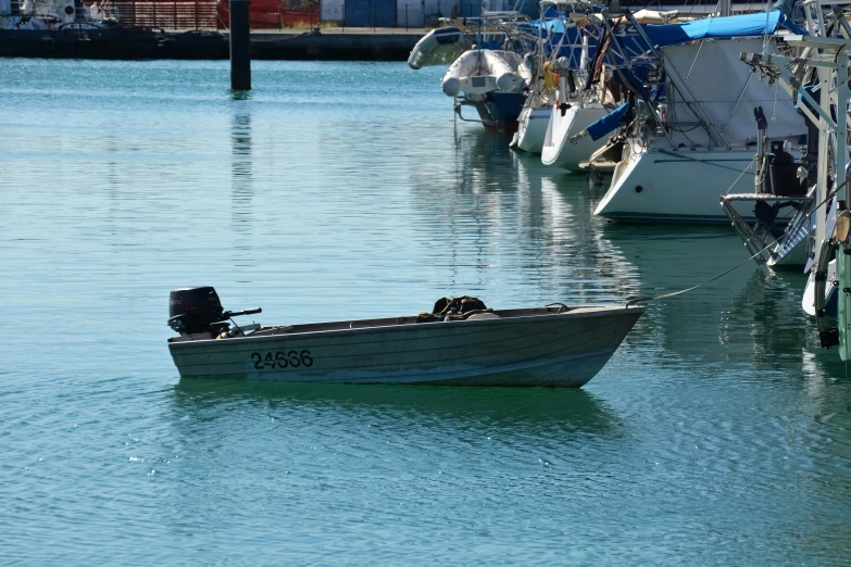 a small boat floats on calm water