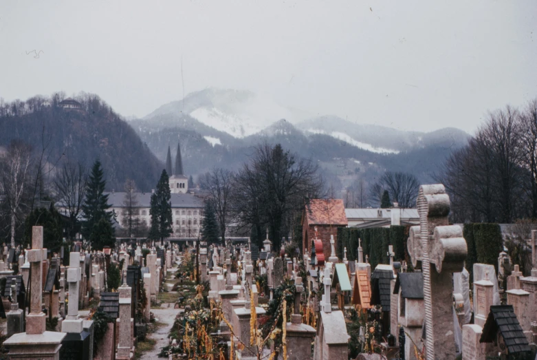 a cemetery and mountains with trees in the background