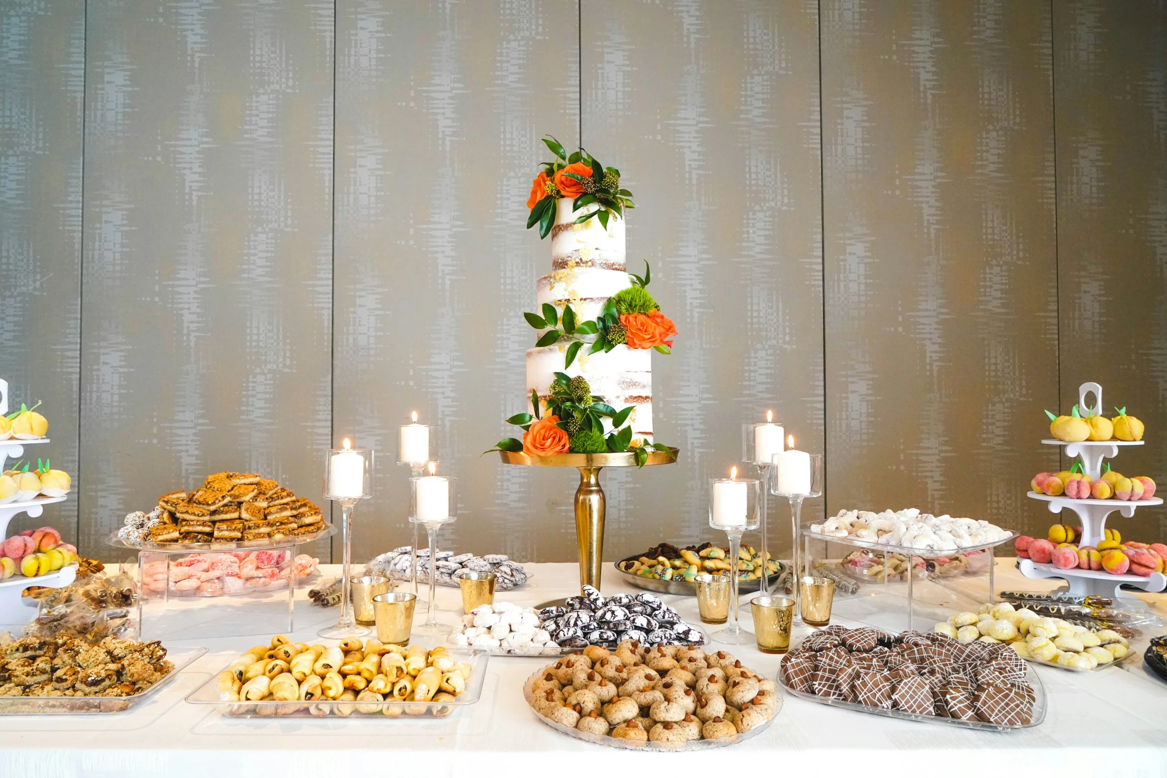 an elegant dessert table set up for a reception