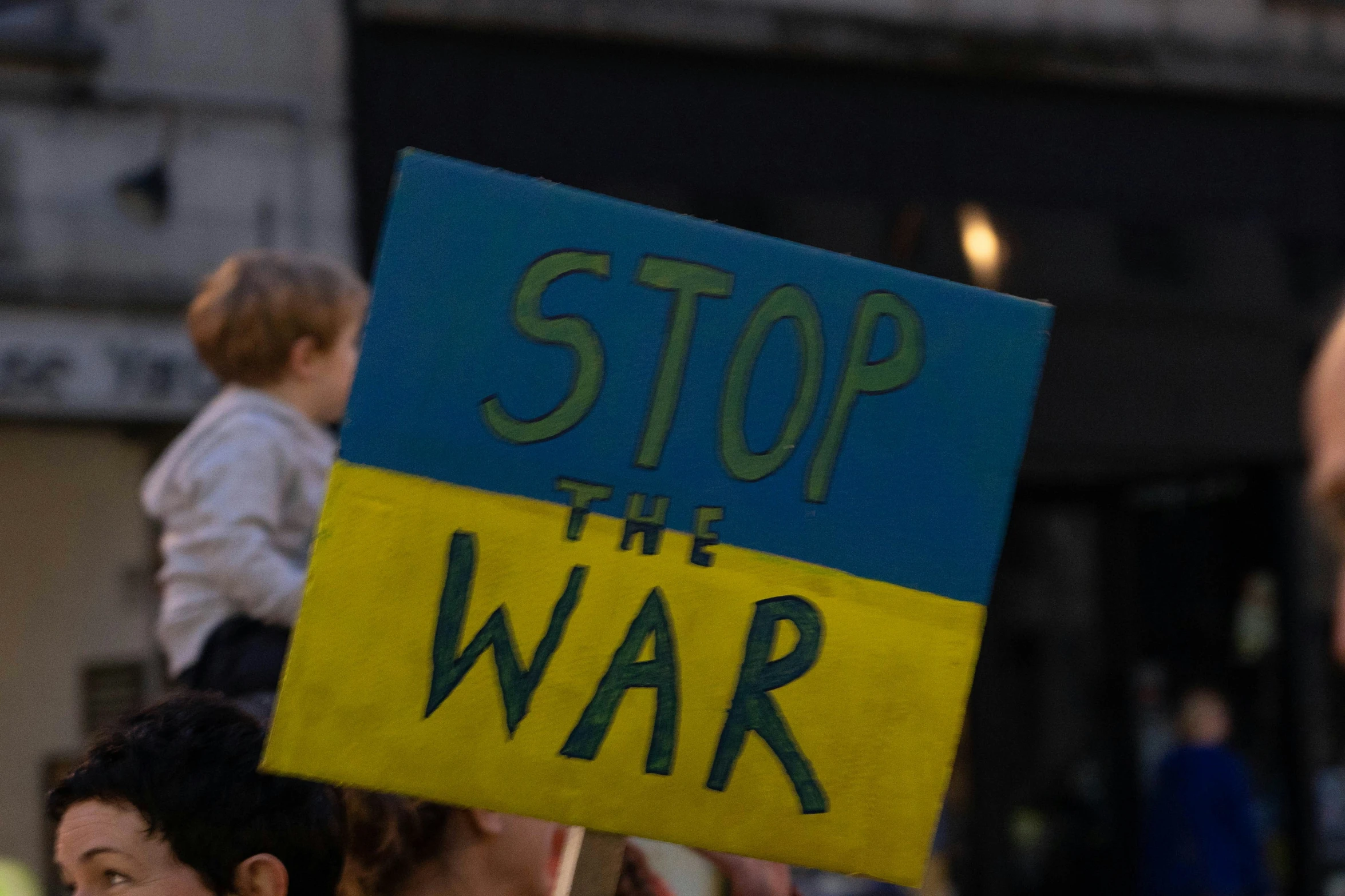 people carrying signs in the air with people around them