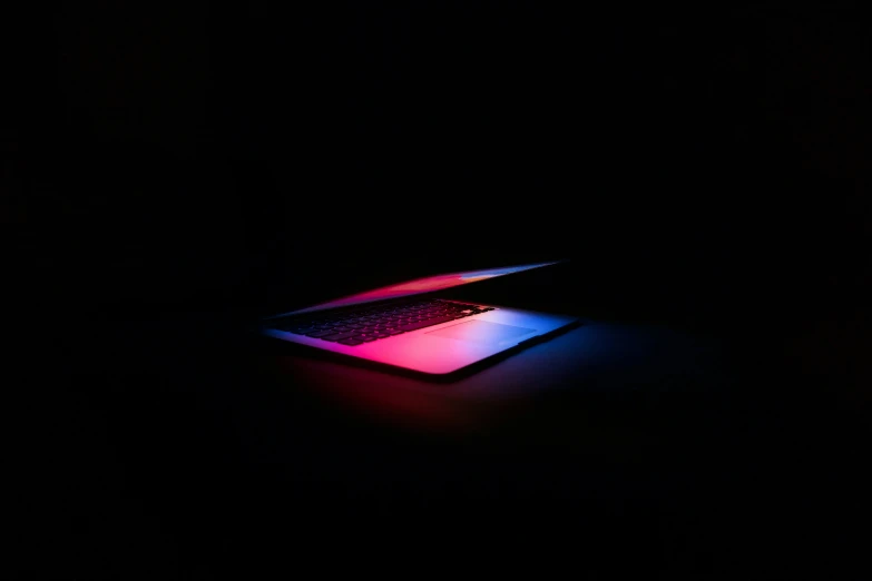 an illuminated laptop on top of the computer