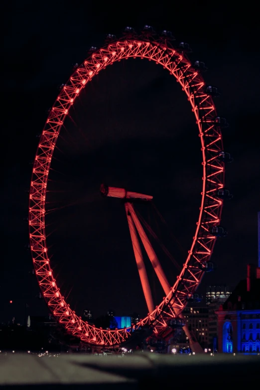 a large ferris wheel with lights shining around it