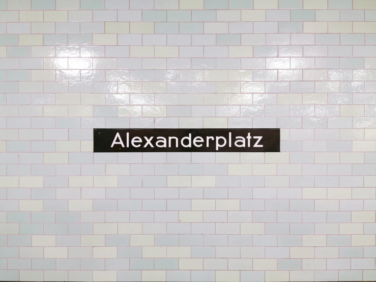 a subway sign with the name alexandria plaza on it