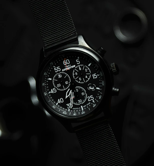 the black watches is displayed on a dark surface