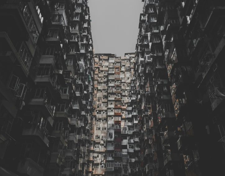 a group of buildings with balconies that are vertically up and down