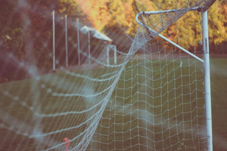 the corner of a goal with a ball stuck in it