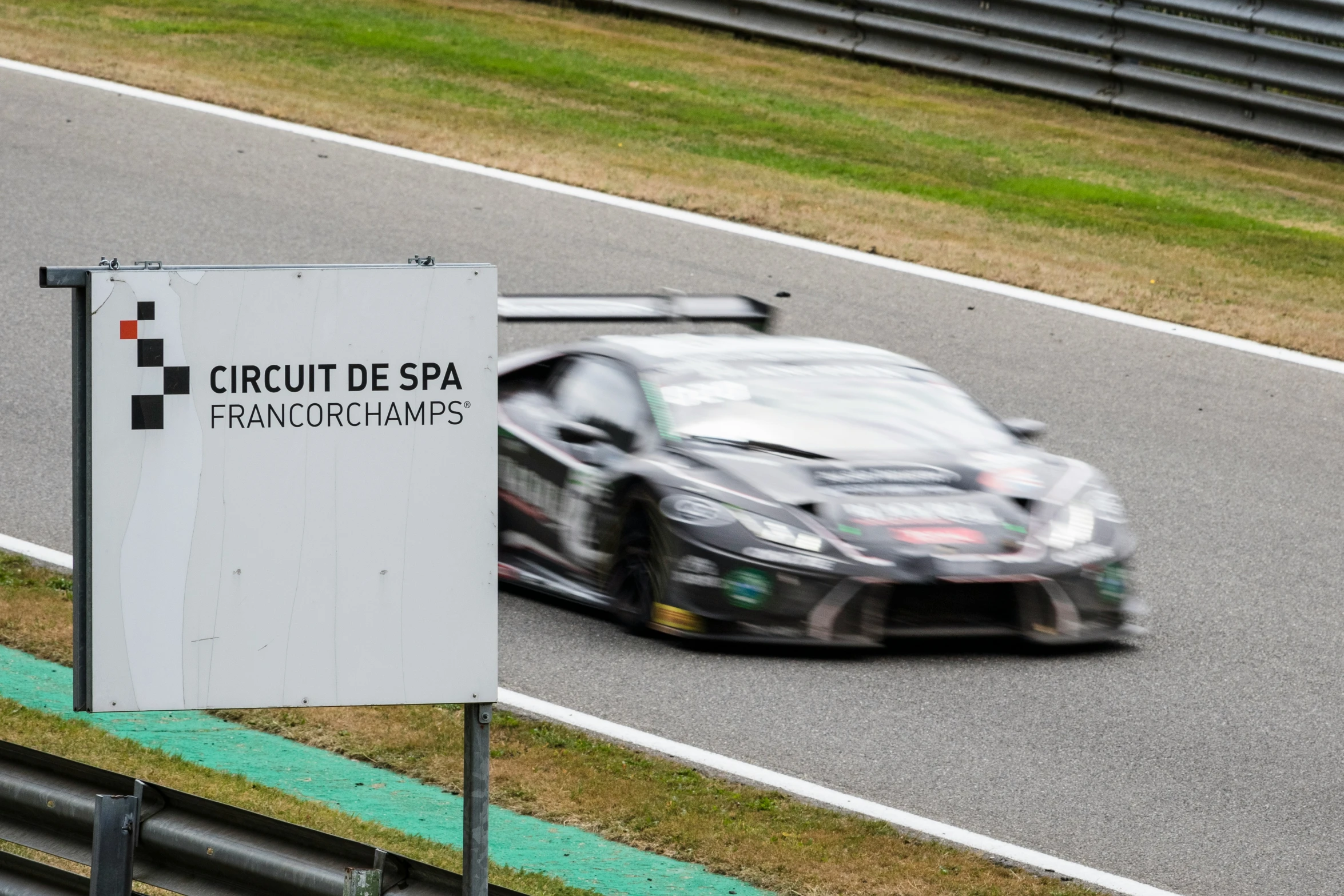 a car driving on the side of a road with a sign that says circuit de spa