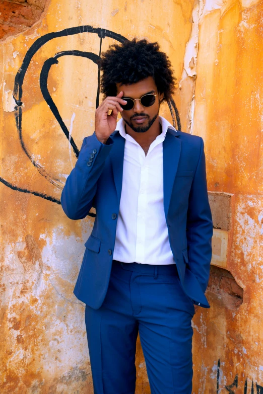 a person in a suit and sunglasses is talking on the phone