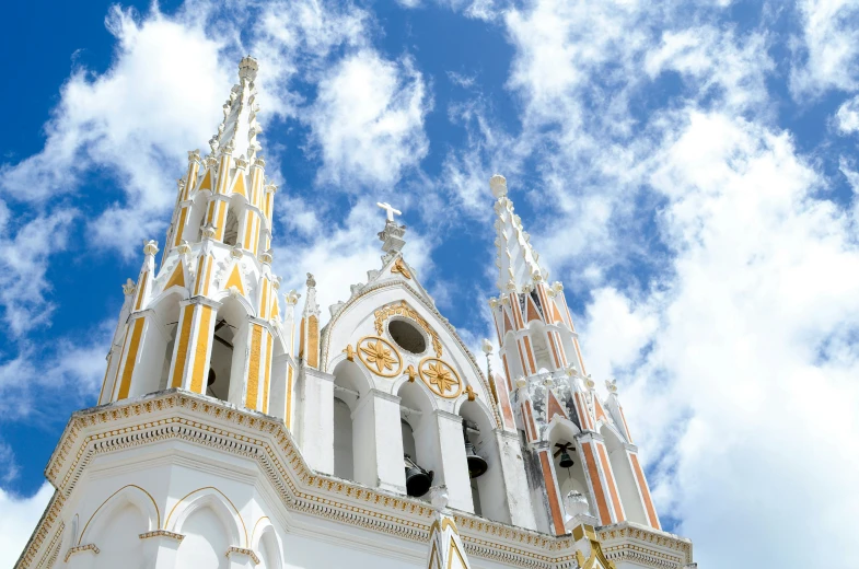 the cathedral is white and has two clocks on each side of it