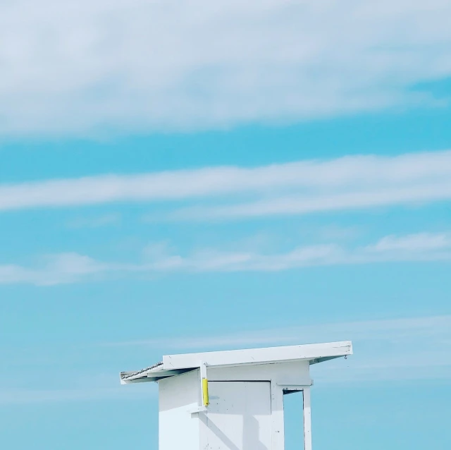 an empty beach with a lifeguard booth on the shore