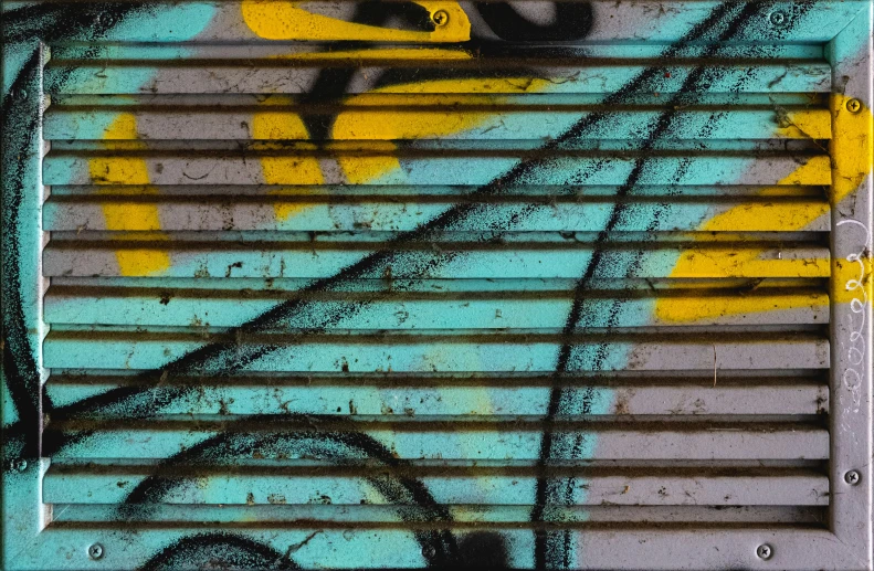 graffiti written on a window is shown with yellow and blue graffiti