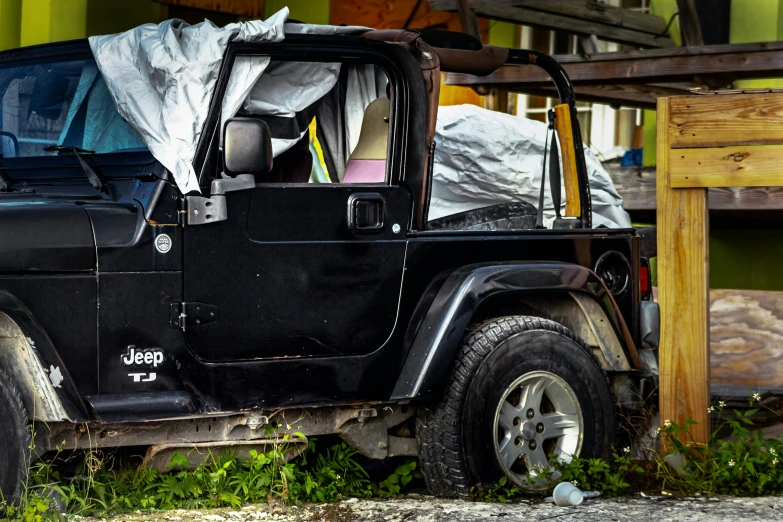 a jeep is outside by some grass