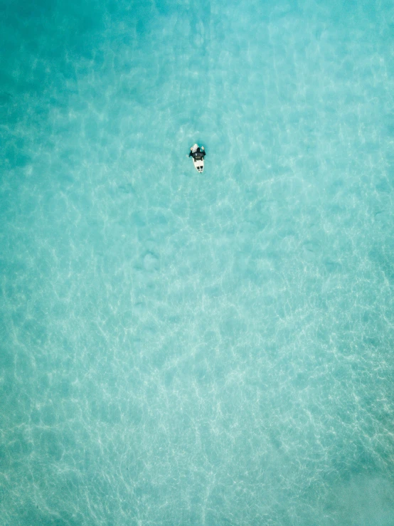 a surfer is on a board in a body of water