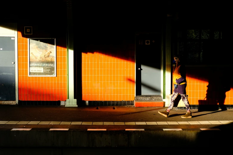 a person crossing a street in front of a train station