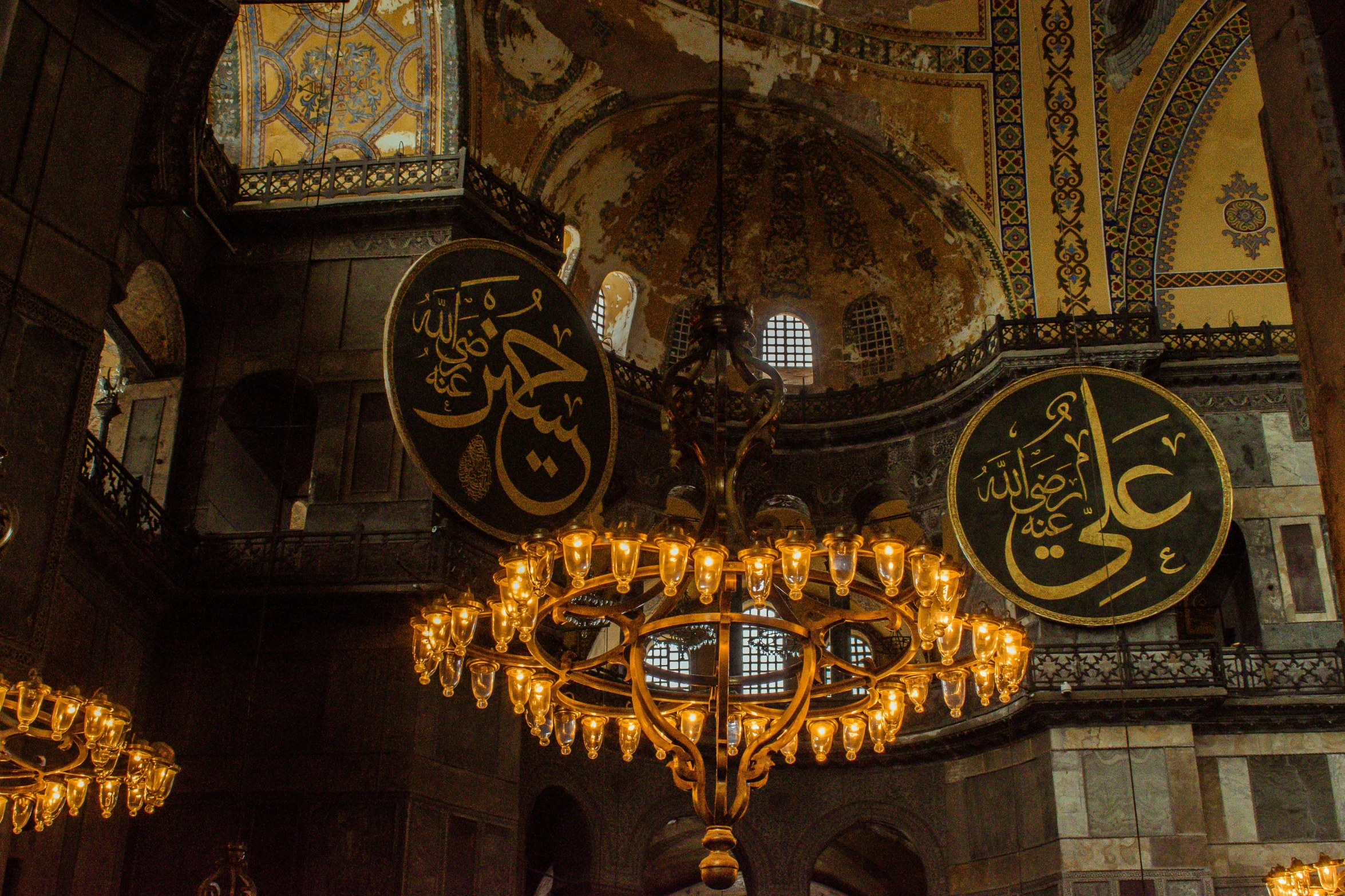 a mosque decorated in arabic style with chandelier