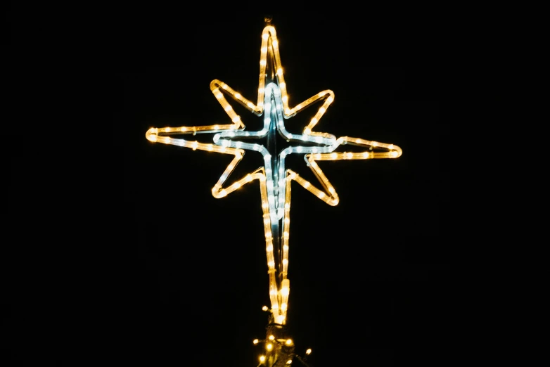 a christmas tree in the dark with lights on