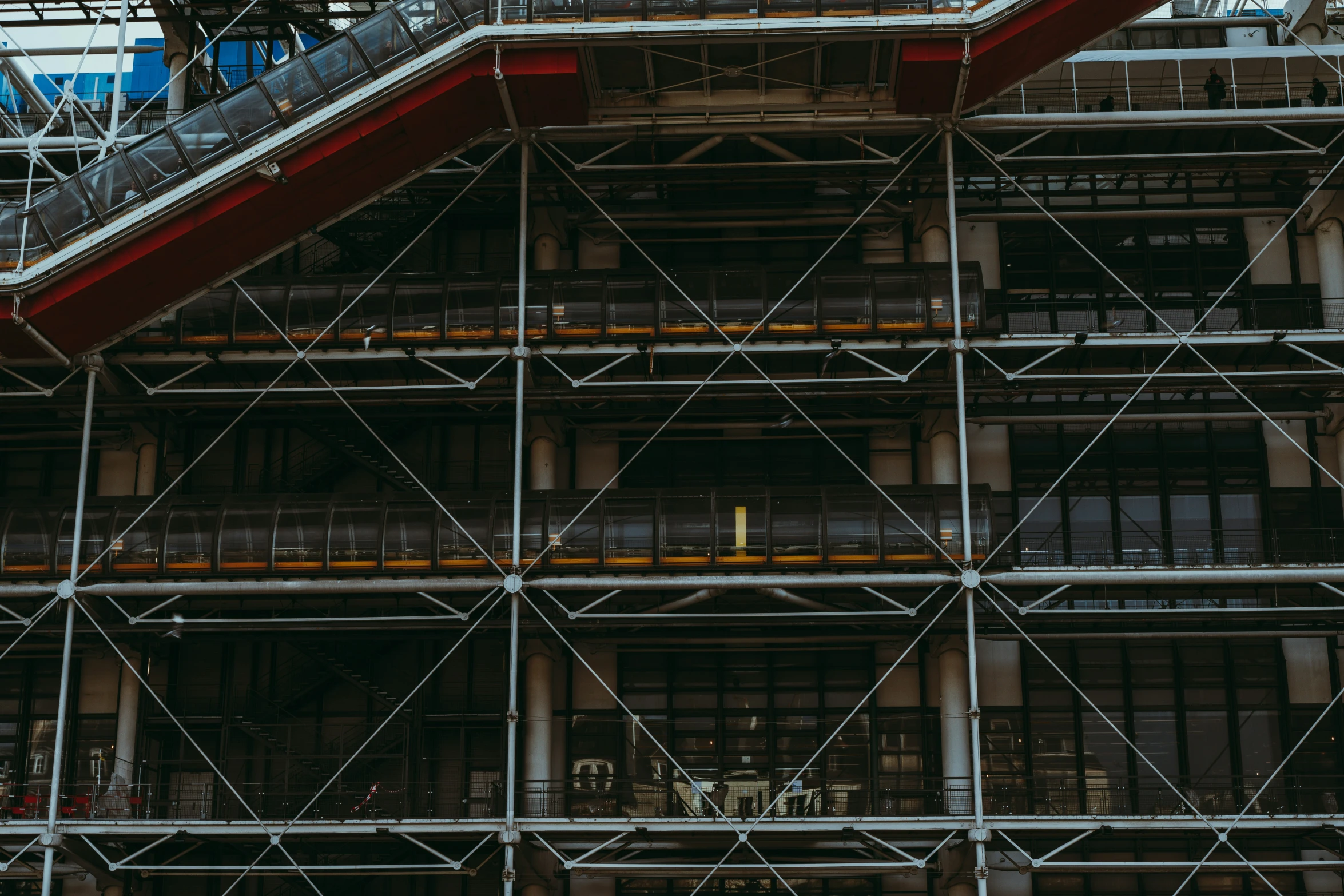 two workers stand on the top of an architectural scaffold