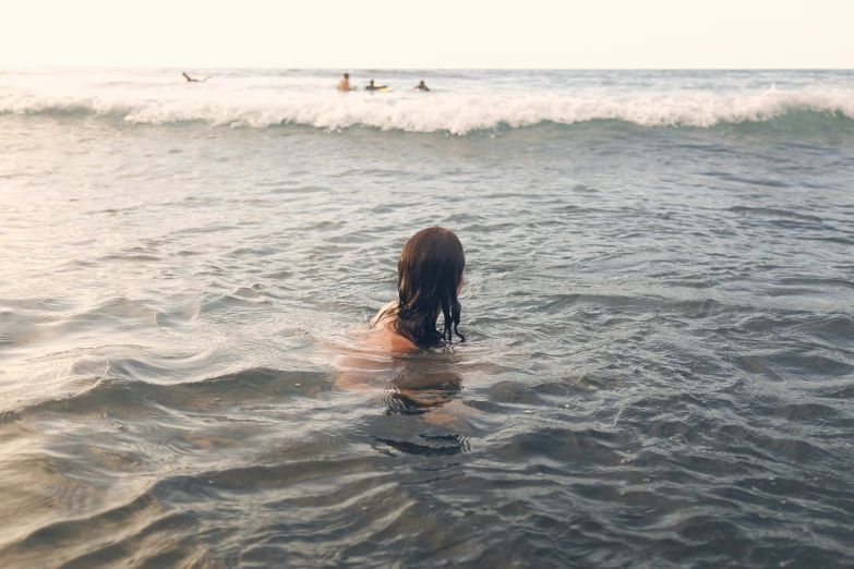 a woman riding on top of a body of water