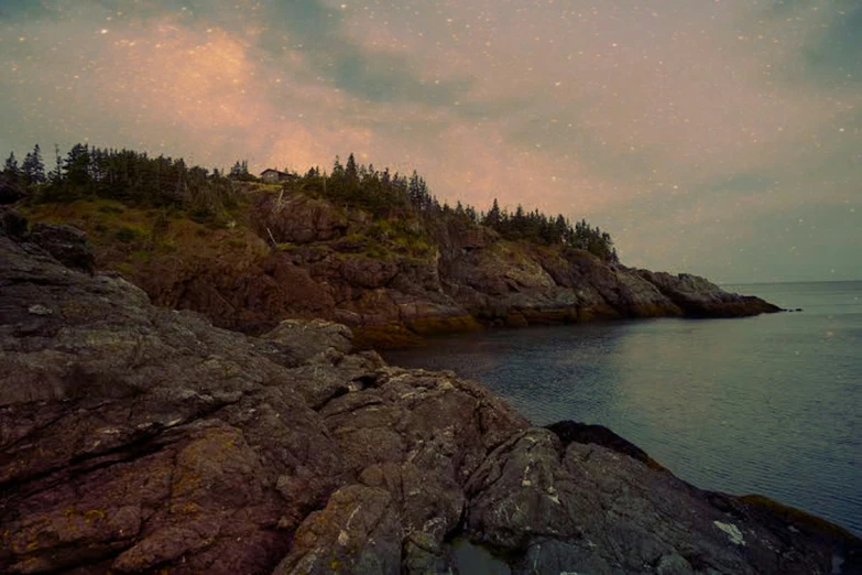 there is a lighthouse and a tree line at the end of the cliffs