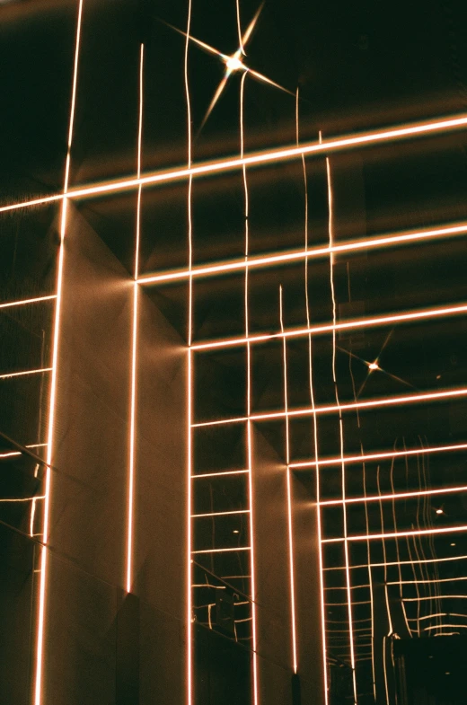 lights are lit up over a ceiling in a dark room