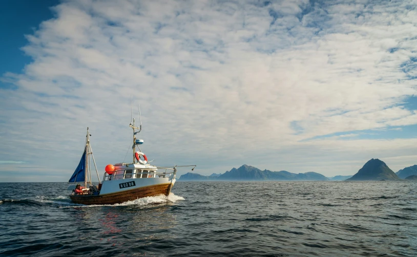 a boat is floating on the water on the cloudy day