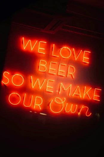 an illuminated neon sign reads, we love beer so we make our sum